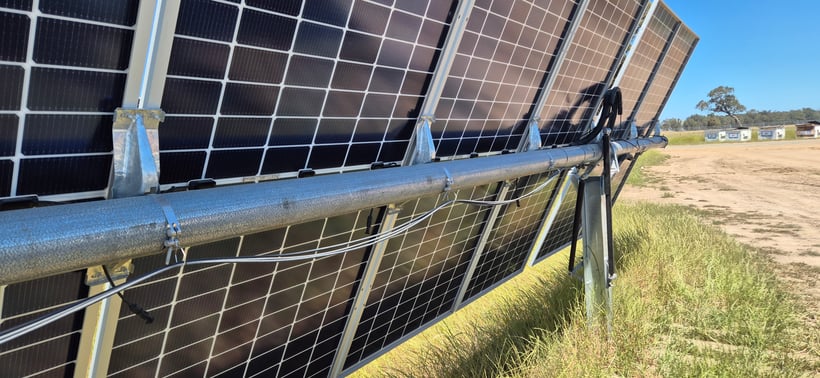 Organised string cables secured in ECLIPZ hangers along Nextracker torque tube at Culcairn Solar Farm showing tidy cable routing