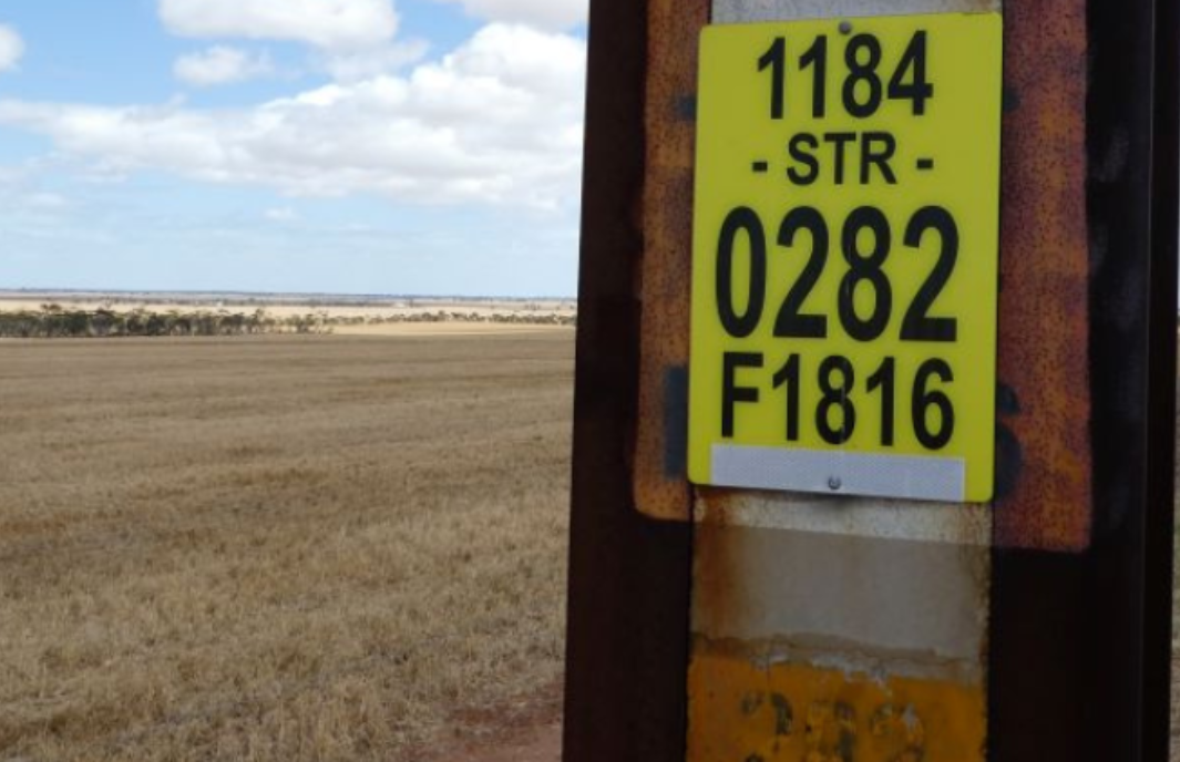 Yellow identification sign on an SA Power transmission pole