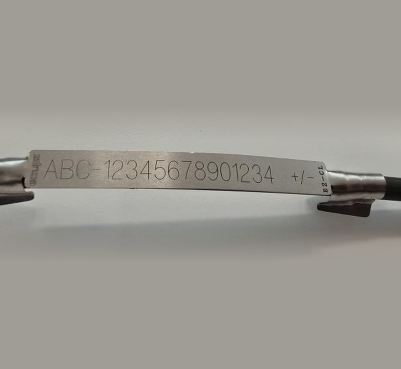 ECLIPZ E2-CL stainless steel cable label clipped onto a cable, laser engraved with an asset number